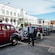Vintage cars from Art Deco Trust, Vintage Car Tours, lined up on a street with drivers in period clothing